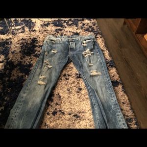 Ripped Levi 501 blue jeans.